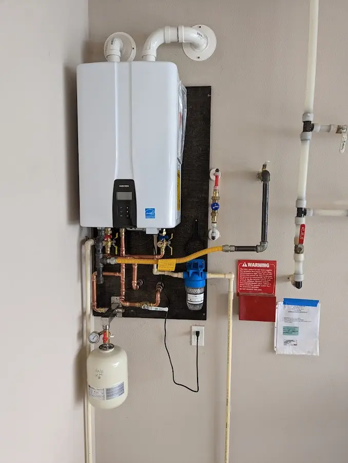 Professional plumber installing copper piping in a Deerfield home